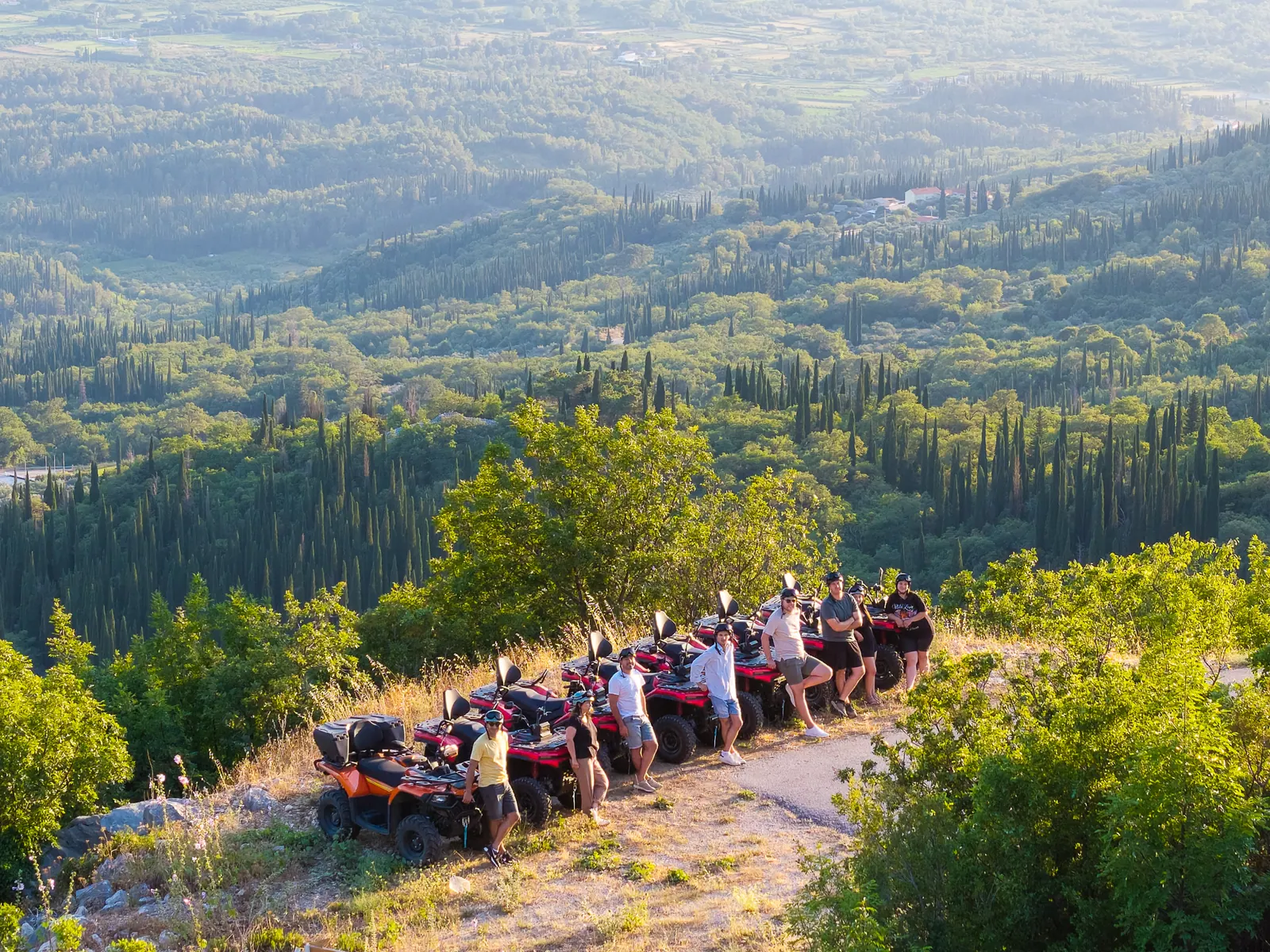 Golden hour drone shot of the group parked above the valley