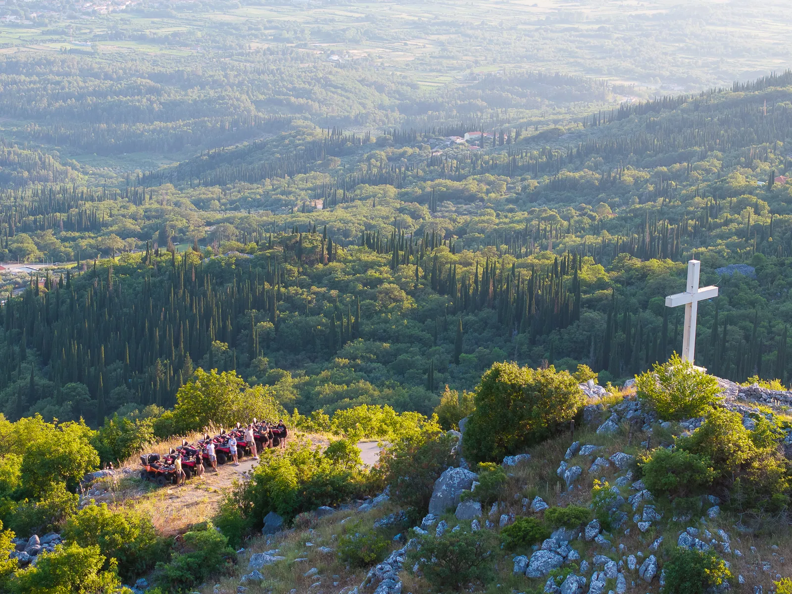 White cross at the St. Barbara viewpoint above the Konavle valley at sunset